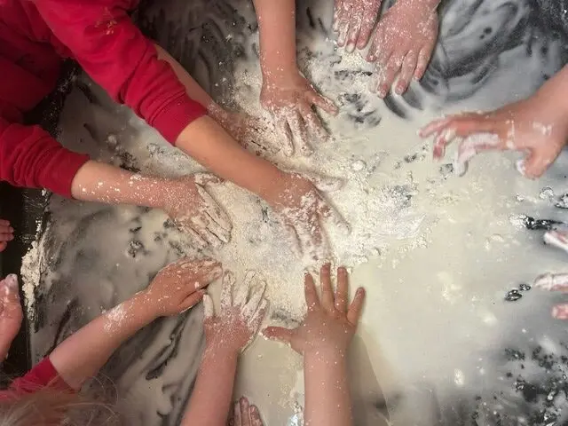 Children's hands exploring a sensory play activity